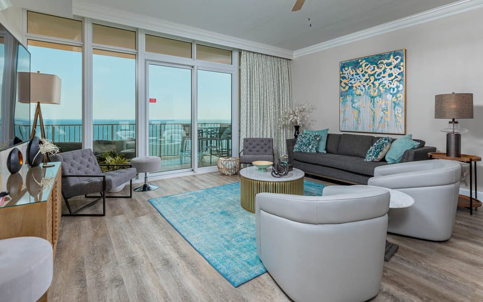 Relax in the living area, featuring a queen sofa sleeper, stylish decor, and coastal views that create a serene vibe