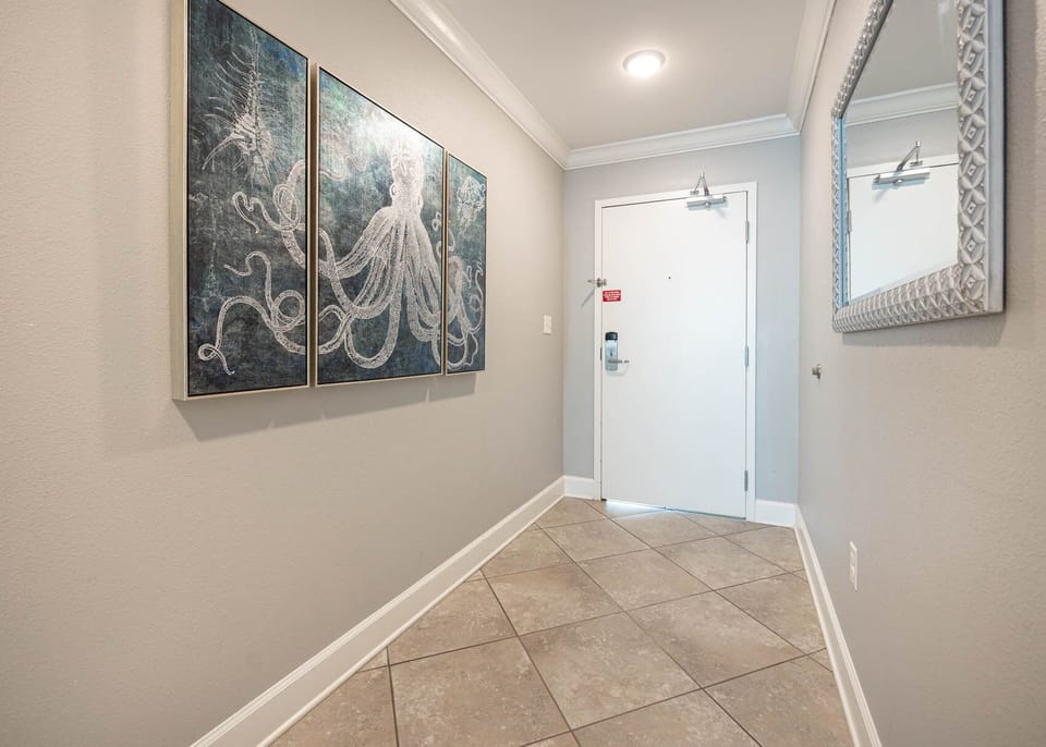 Enter this inviting space greeted by charming artwork and a welcoming vibe, setting the tone for your beach getaway