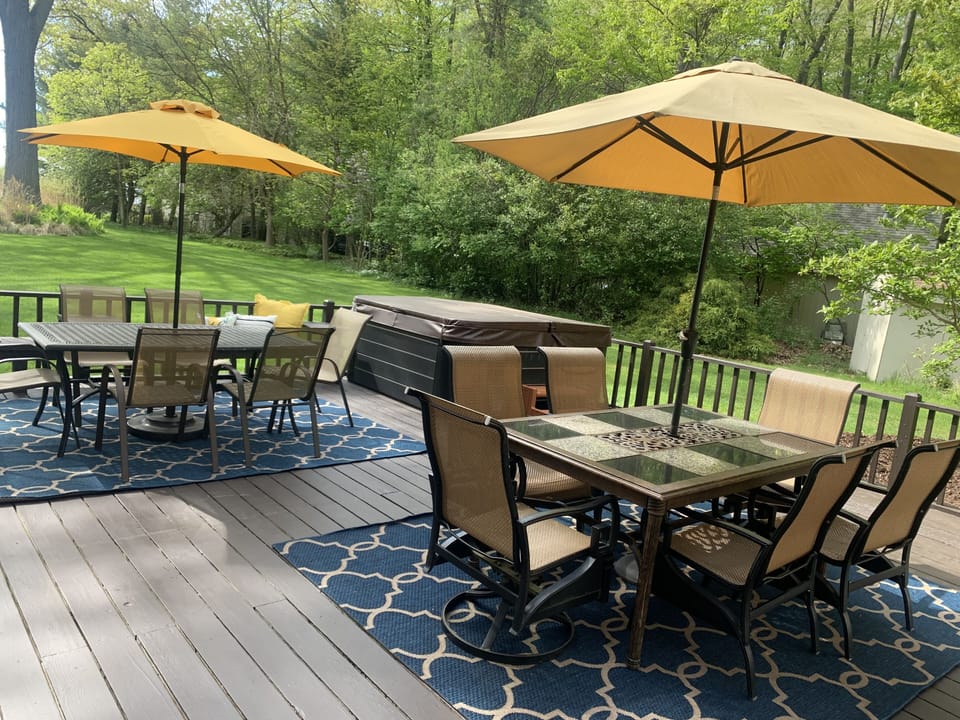 Large deck with two patio sets and additional built in seating.  