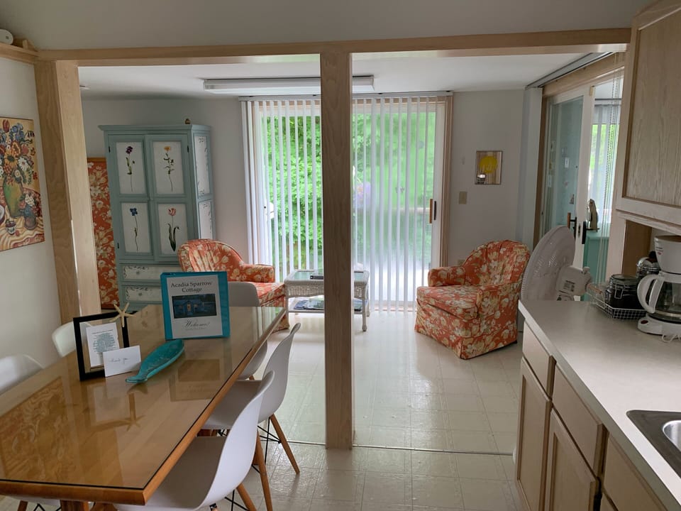 Kitchen & sitting area & sliders to deck, full bed to left, twin bedrm on right