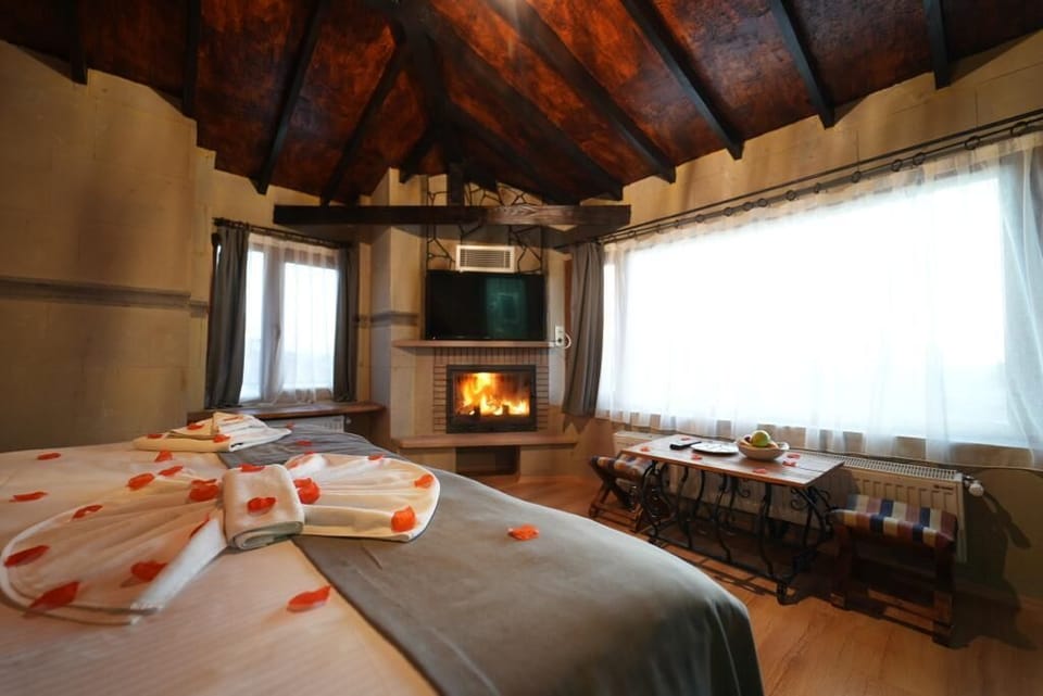 Deluxe Room, Fireplace, City View | Living area | LCD TV