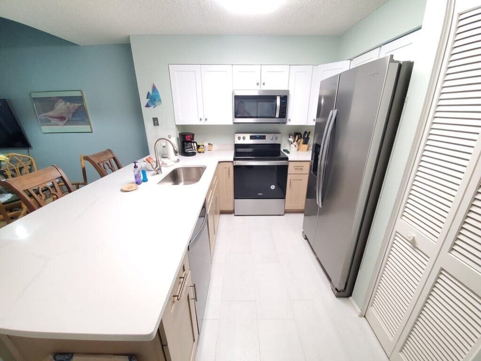 Modern and fully-equipped kitchen with spacious countertops and stainless steel appliances.