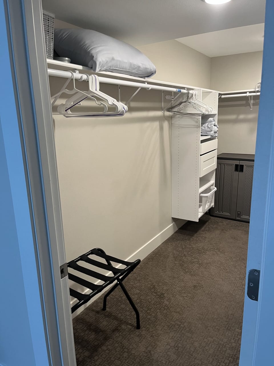 Master bedroom closet with hangers, valet and shelves. 