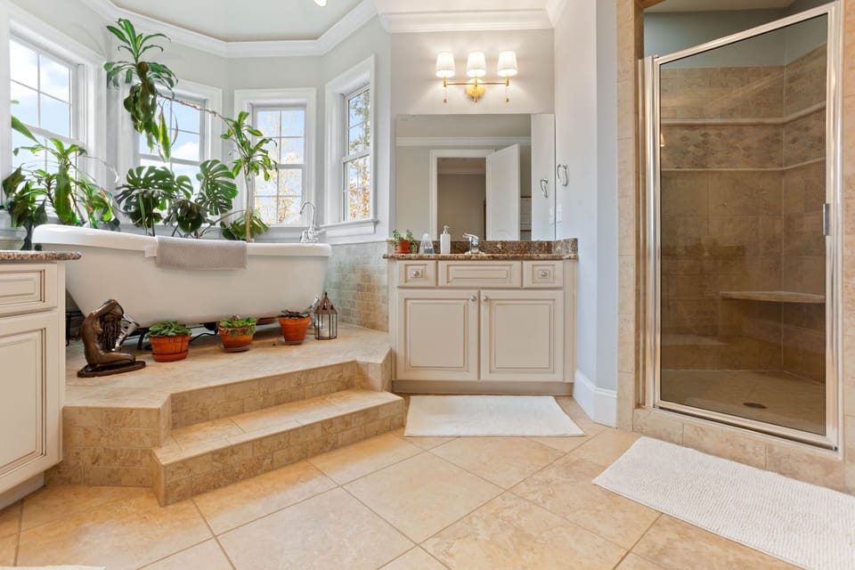 Primary bathroom with a jetted claw foot tub. 