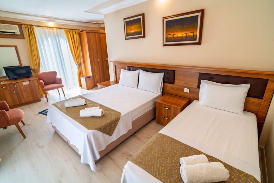 Family Triple Room | Premium bedding, minibar, laptop workspace, blackout drapes