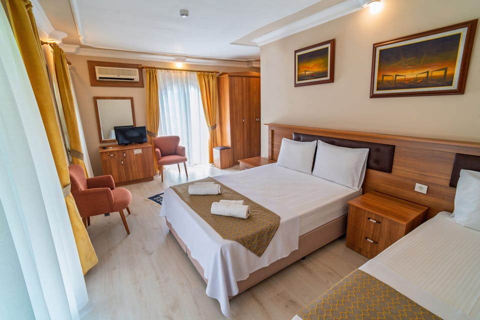 Family Triple Room | Premium bedding, minibar, laptop workspace, blackout drapes