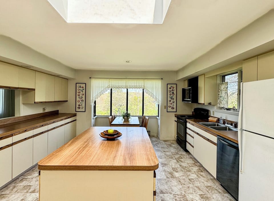 large eat in kitchen with oven, dishwasher, refrigerator and plenty of storage