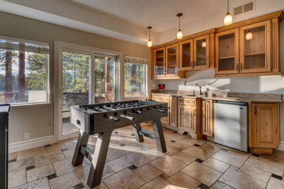 Game room with Foosball table, wet bar with sink and mini fridge