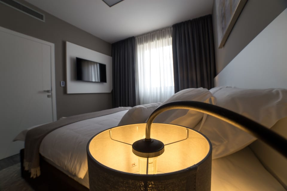 Junior Suite, Garden View | Premium bedding, minibar, in-room safe, individually decorated