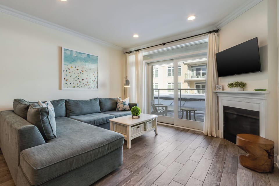 Pool views from your comfy couch in the living room. TV and gas fireplace too.