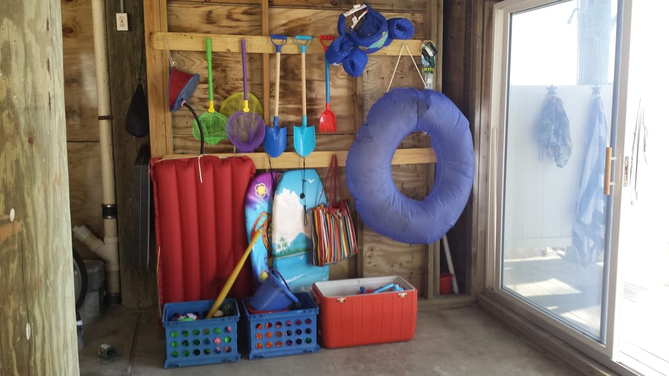 Beach toys include fishing poles, volleyball, bocci ball, c-hole, sand toys