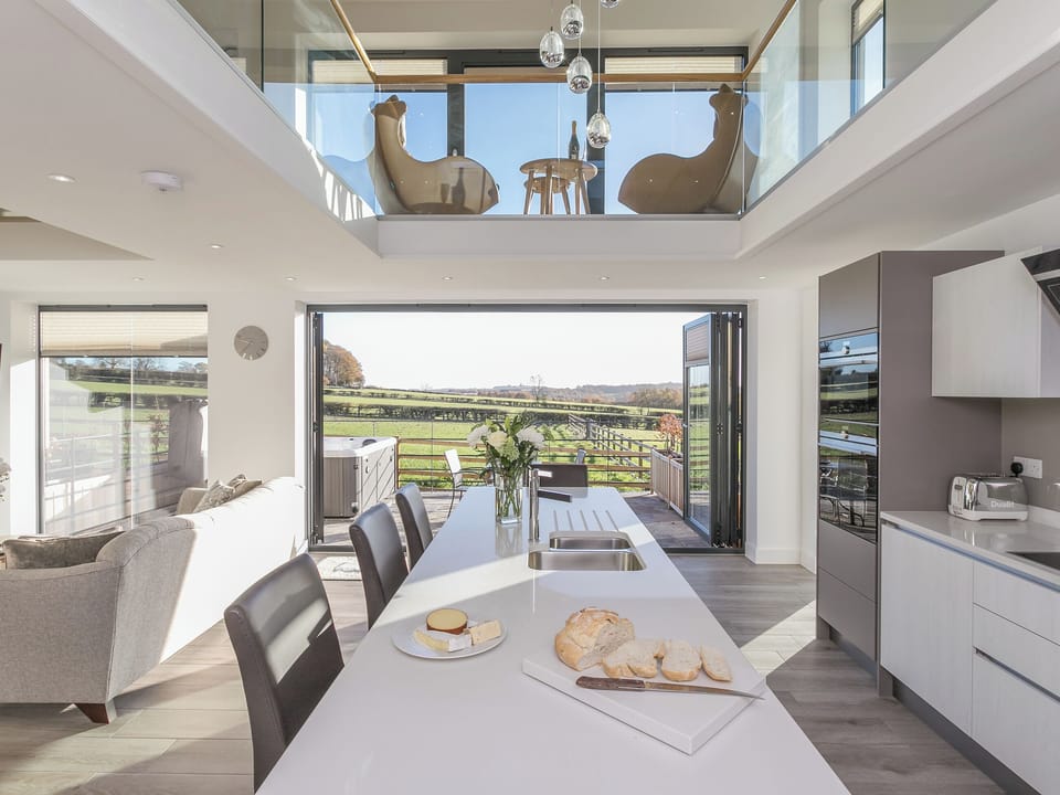 Open-plan living area with bi-fold doors to patio area | The Lookout - Broadstone Barns, Ticknall, near Derby
