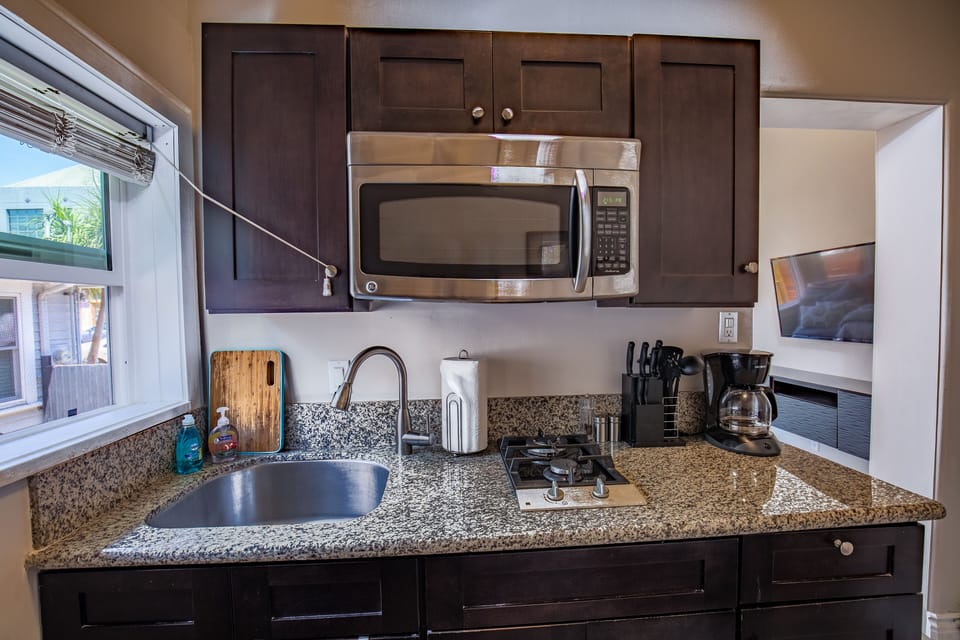 Fully Stocked Kitchen with Stainless appliances, Granite counter top, Gas Stove top, microwave and kitchen table with barstools, cozy spot for morning coffee!