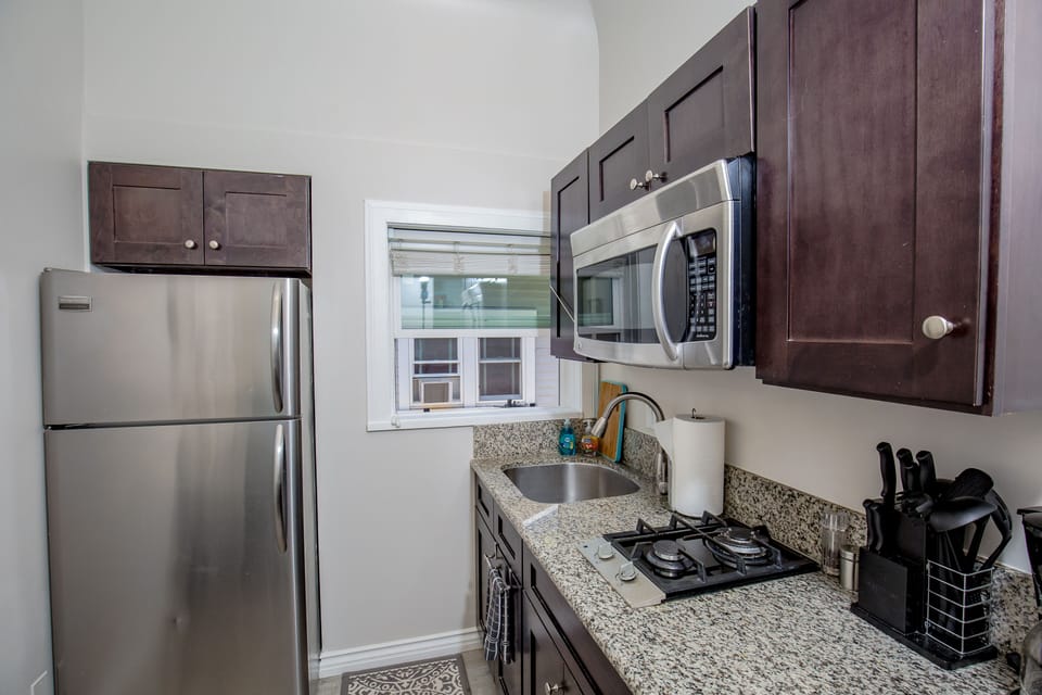 Fully Stocked Kitchen with Stainless appliances, Granite counter top, Gas Stove top, microwave and kitchen table with barstools, cozy spot for morning coffee!