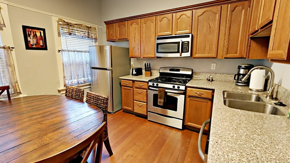 Full Kitchen with Stainless Steel Appliances and Wooden Features
