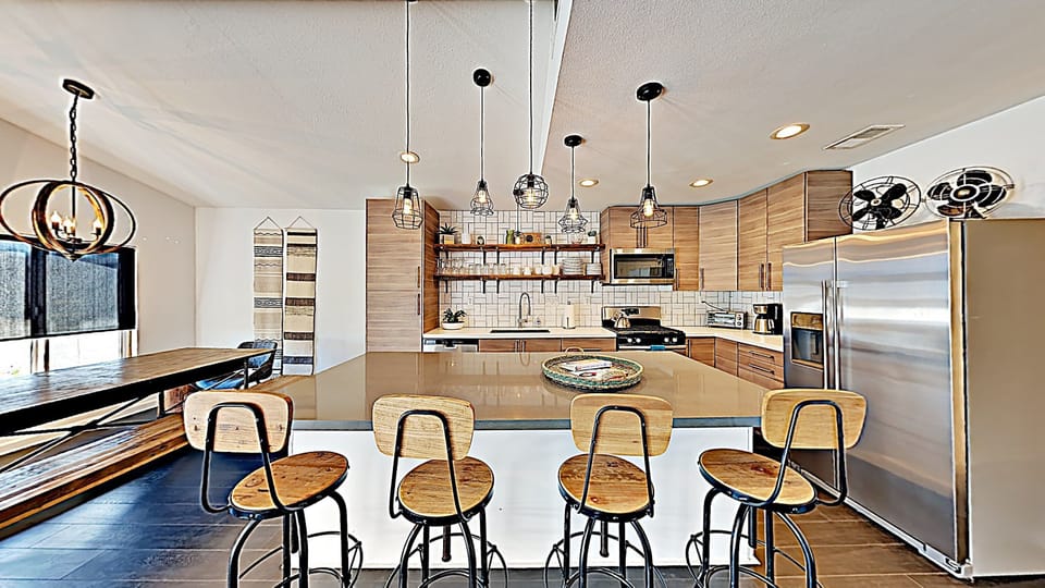 Open Concept New Kitchen counters, cabinets and appliances, island with bar stools for 4 & large dining table that seats up to 10 people.