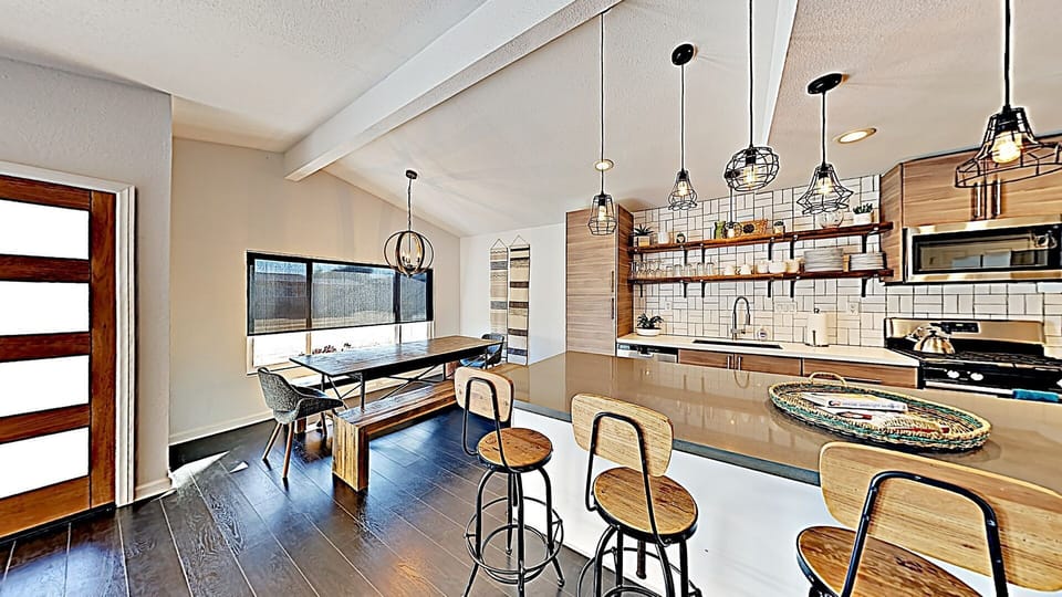Open Concept New Kitchen counters, cabinets and appliances, island with bar stools for 4 & large dining table that seats up to 10 people.