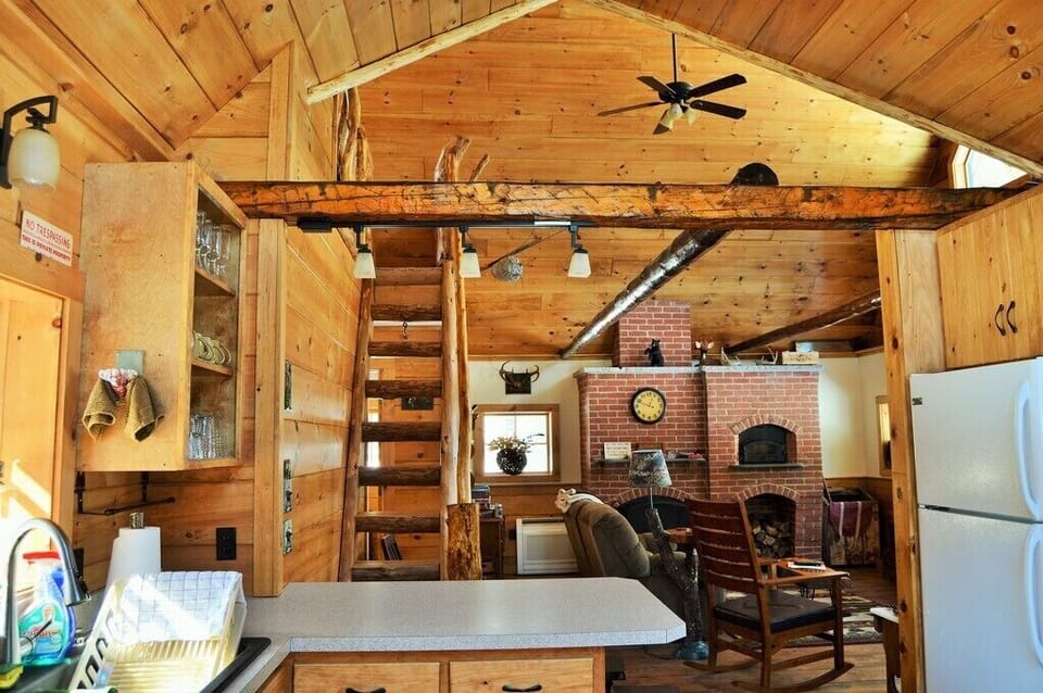 View of living room and loft stairwell from the kitchen