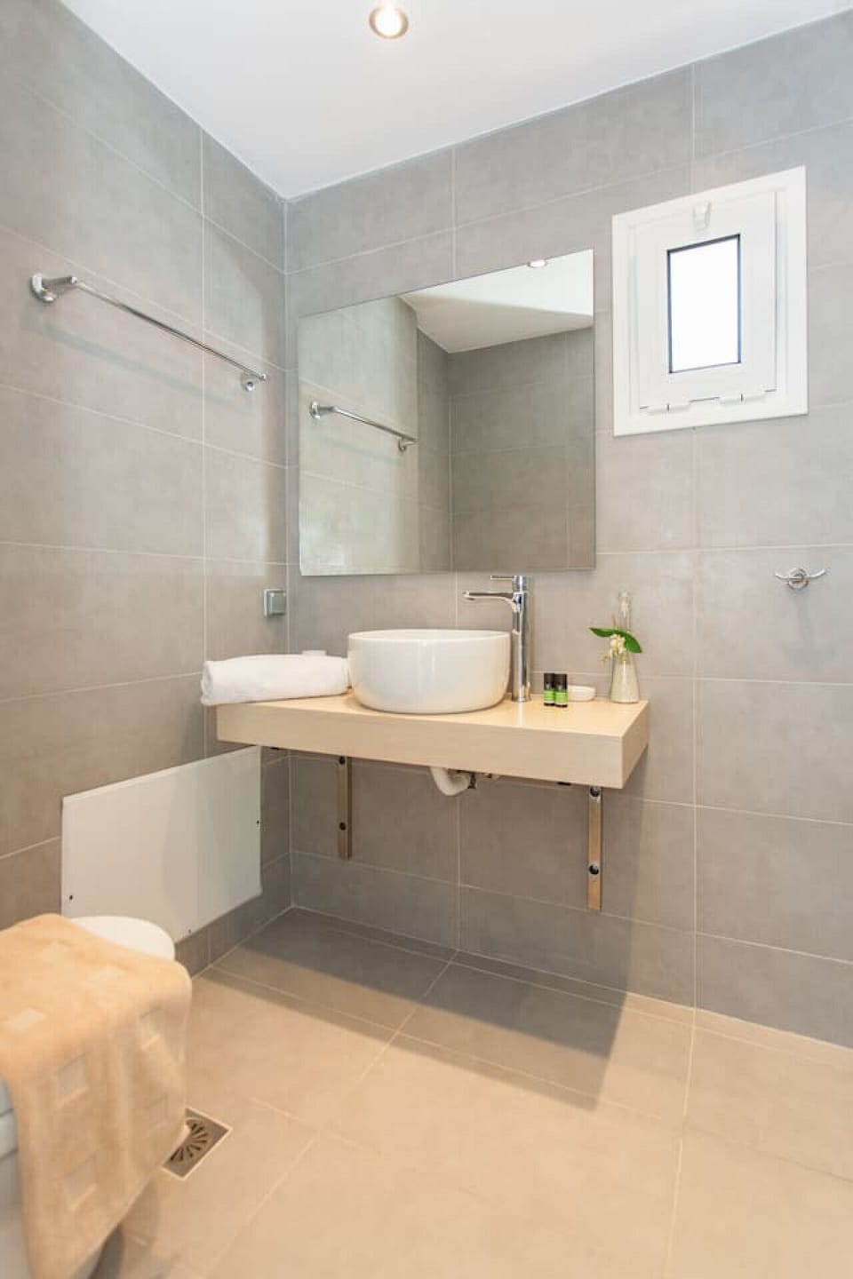 Fully equipped bathroom with fresh towels, toiletries, and essential amenities.