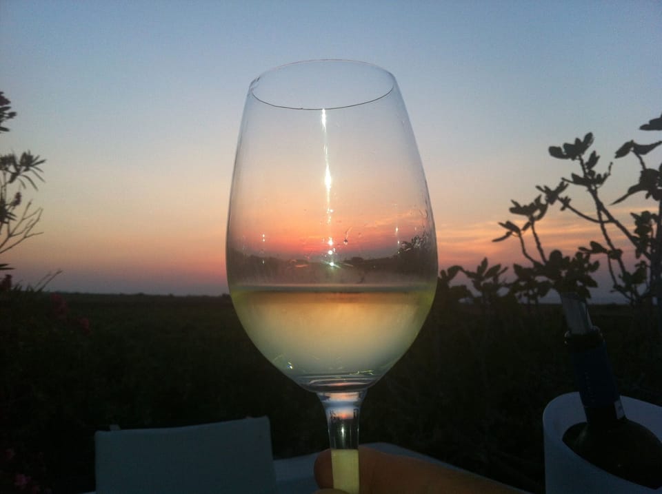 enjoying  the sunset with a glass of wine..
