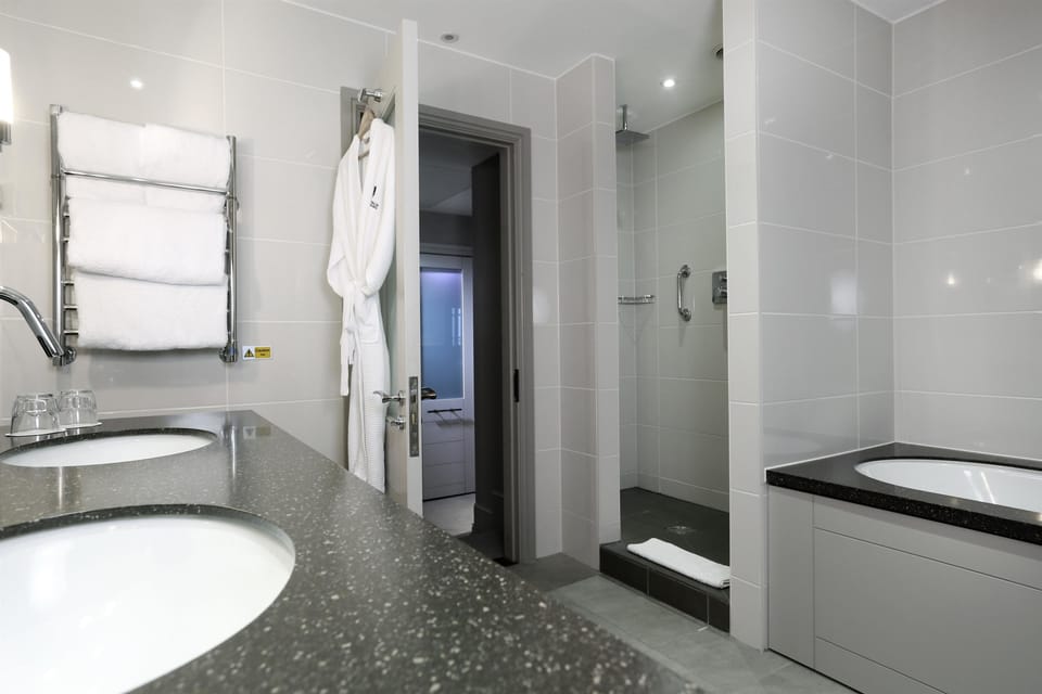 Designer toiletries, hair dryer, slippers, towels
