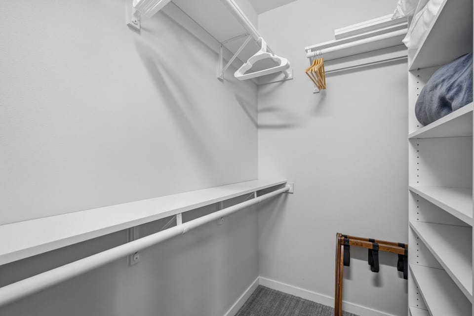 Your walk-in closet offers plenty of hanging space and built-in shelving, making it easy to keep your wardrobe organized throughout your stay.