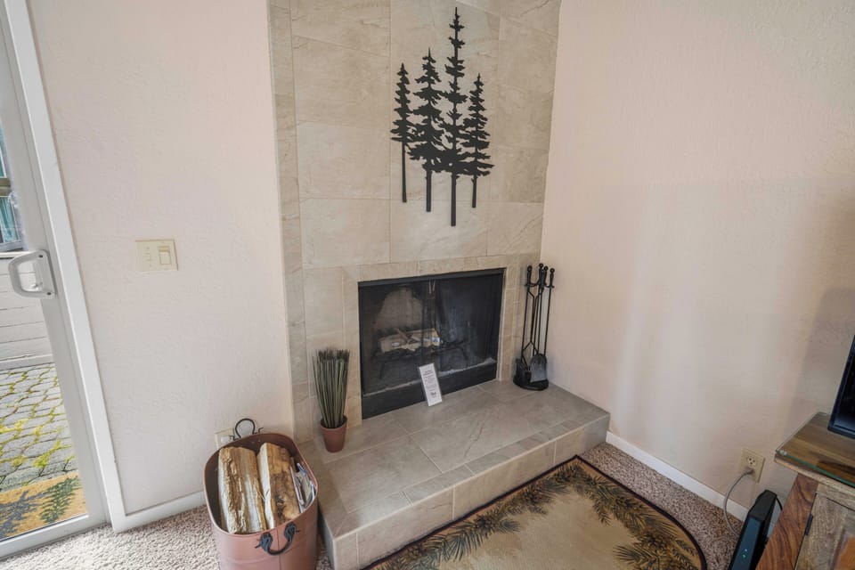 Gather by your own corner fireplace, where tall ceilings and minimalist décor frame a peaceful place to unwind after exploring the mountains.
