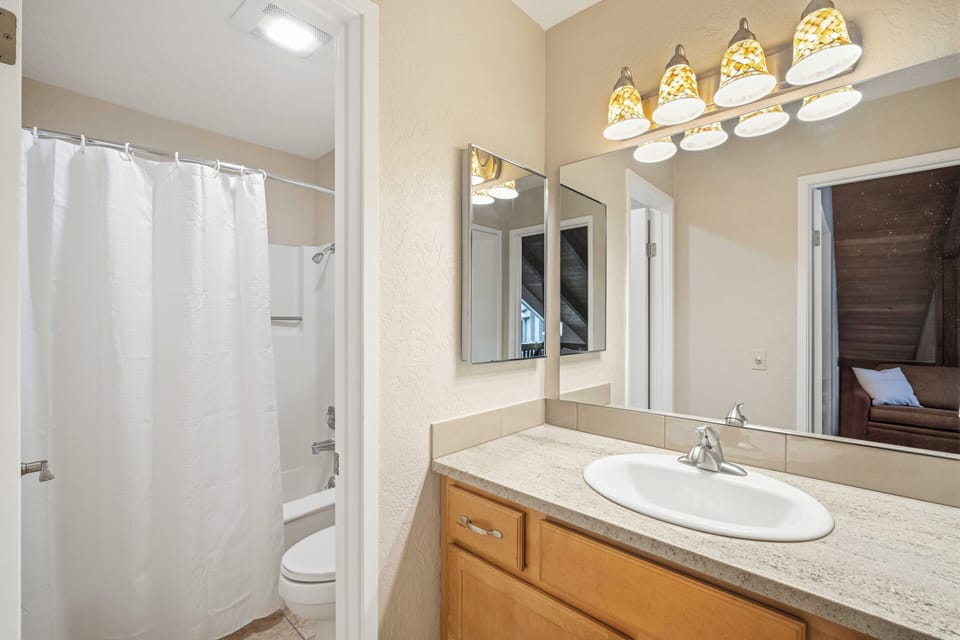 Freshen up in your private bathroom with a spacious vanity, ample lighting, and a relaxing shower-tub combo to unwind after your adventures.