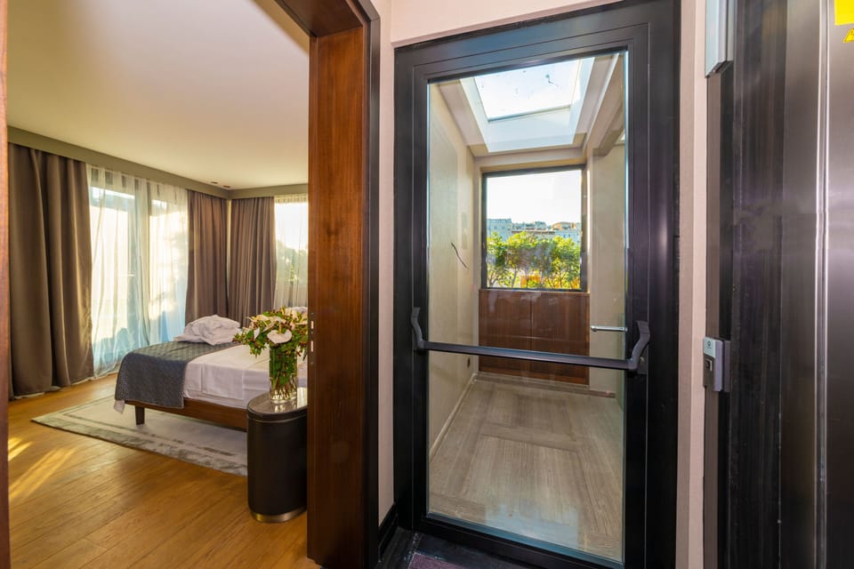 Panoramic Double Room, Balcony, City View | Minibar, in-room safe, soundproofing, iron/ironing board