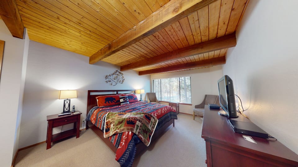 Unwind in the illuminated hot tub surrounded by natural rock features, then take a dip in the adjacent pool—all under dramatic timber beams and bright skylights.