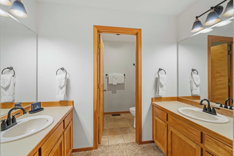 Freshen up in your private dual-vanity bathroom, complete with plush towels and a separate toilet room for added privacy.