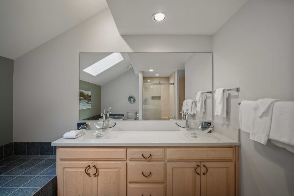 Step into your spacious master bathroom with dual vanities, perfect for getting ready together on vacation mornings.