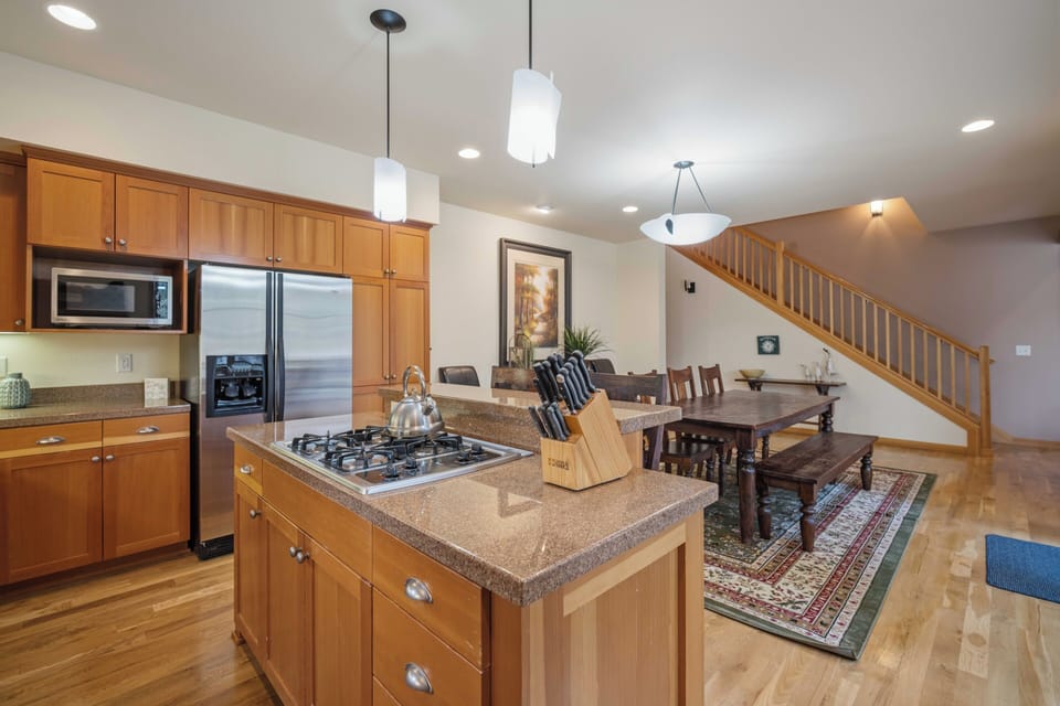Your spacious open kitchen features granite counters, stainless appliances, and flows seamlessly into the warm dining area.
