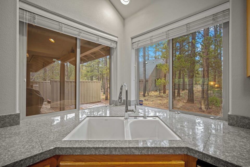 Your corner kitchen sink offers peaceful forest views while you prepare meals, creating a serene cooking experience surrounded by nature.