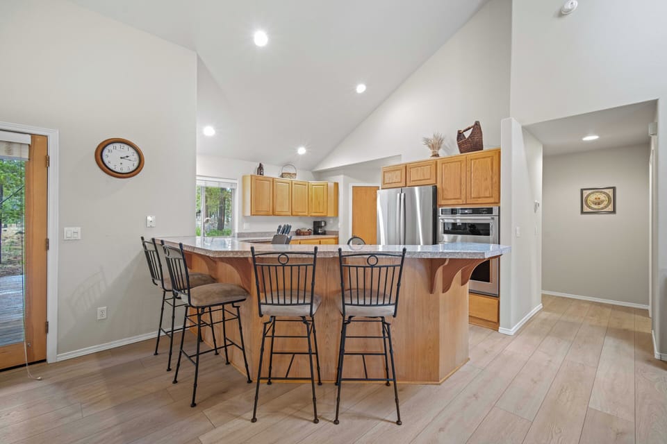 Your spacious kitchen island awaits with warm wood finishes and modern appliances, perfect for morning coffee or evening meals together.