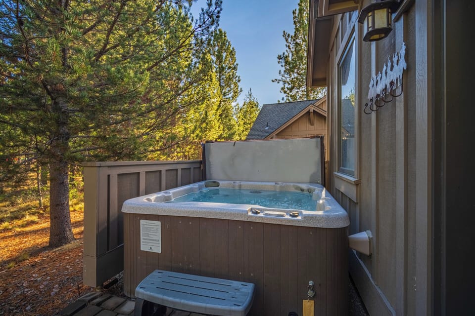 Unwind in your private hot tub surrounded by towering pines, where bubbling warm water and forest serenity create the perfect evening escape.