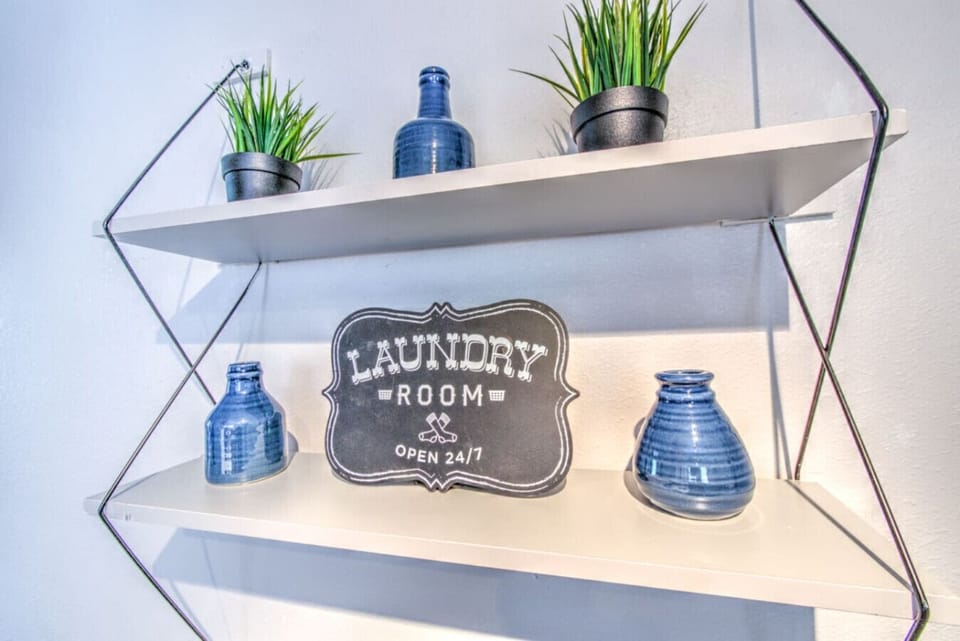 Decorative accents brighten the shelf and elevate the laundry space.