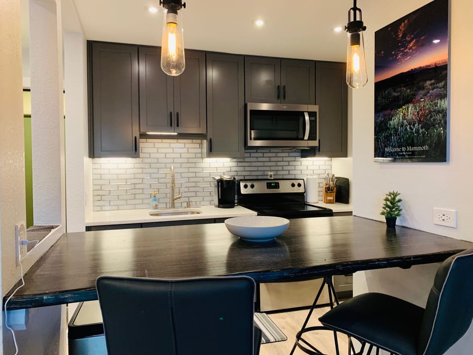 fully stocked kitchen for cooking and serving meals 
