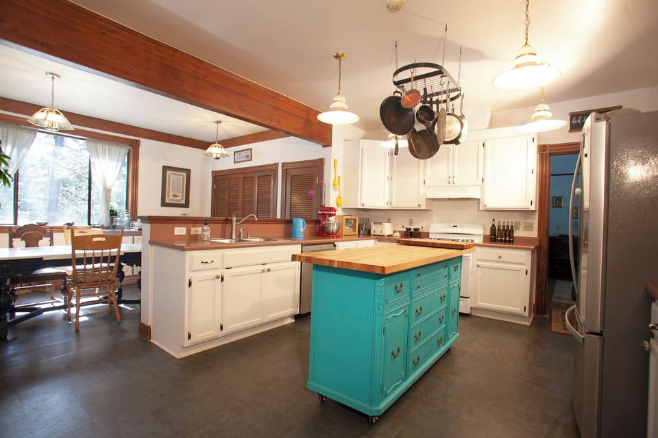 Kitchen view from entry, with view of door leading to parlour and other rooms.