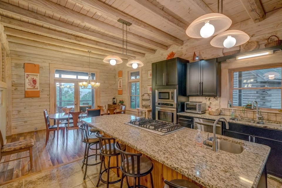 Another view of kitchen and dining area that leads to screened in porch