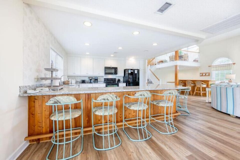 Gather around the stunning kitchen island with your crew, where morning coffee rituals turn into laughter-filled moments. Light-filled and spacious, with all the amenities to cook, share, and make vacation memories together.