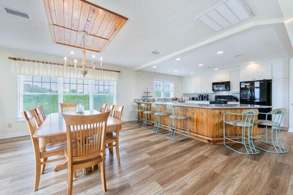Natural light floods your open dining and kitchen area, where farmhouse charm meets modern convenience. Gather around the welcoming table or unwind at the island—this space invites you to cook, share meals, and create memories together.