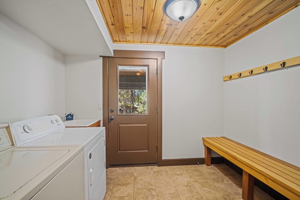 Your private laundry room features full-sized washer and dryer, plus a spacious bench and coat hooks—perfect for easy unpacking and keeping your vacation wardrobe organized.