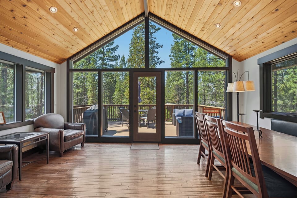 Relax in your inviting living and dining area, where soaring wood-paneled ceilings and floor-to-ceiling windows frame stunning forest views. Step through the French doors to your private deck and breathe in the mountain air.