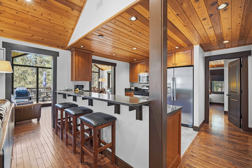 Step into your open-concept retreat where warm wood tones and modern design blend seamlessly. The chef's kitchen features granite counters and stainless appliances, perfect for gathering with loved ones.