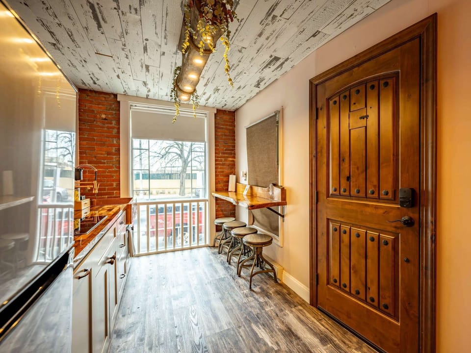 Bright entryway w/ bar seating, large windows &amp; warm wood finishes throughout