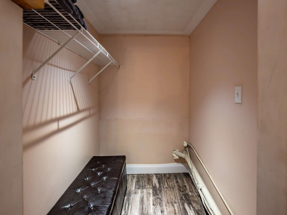 Spacious walk-in closet w/ hanging racks &amp; shelving for easy unpacking
