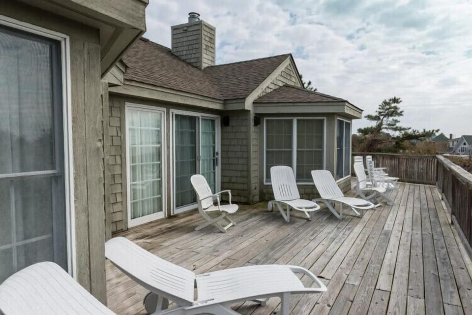 Stretch out on this spacious deck with plenty of lounge chairs for soaking up coastal breezes. Your perfect spot to unwind and enjoy the peaceful surroundings.