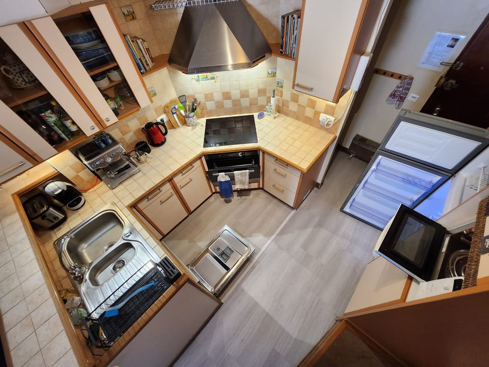 Modernized kitchen with oven, stove, microwave, dishwasher, espresso machine etc