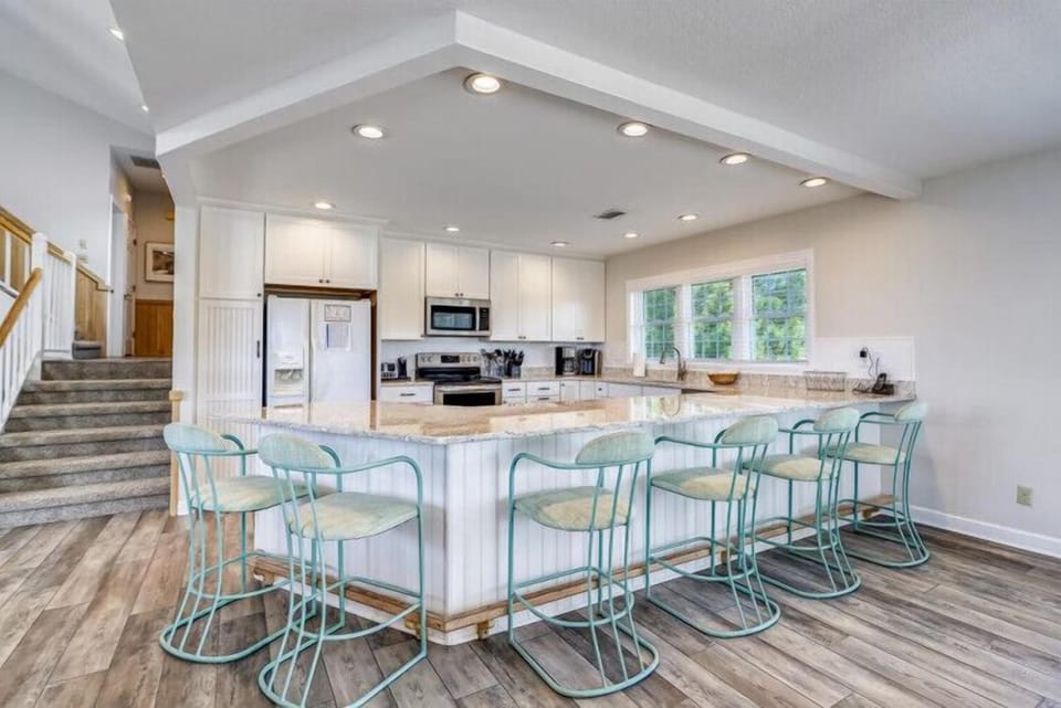 Gather around a spacious island with seating for everyone—your perfect spot for morning coffee, meal prep, or casual conversations. The bright, airy kitchen invites you to cook and connect.